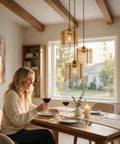 Woman enjoying wine at a table illuminated by milaruoro Farmhouse Pendant Light Fixture, 3 Light Black Wood Pendant Lighting.
