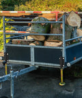 Keep Your Rig Rock Solid With Boss Grade Telescoping Stabilizer Jacks 2500 Lb Capacity on trailer holding logs.