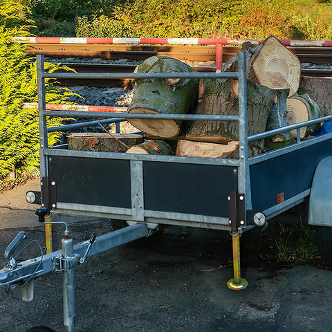 Keep Your Rig Rock Solid With Boss Grade Telescoping Stabilizer Jacks 2500 Lb Capacity on trailer holding logs.