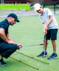 Golf coach using Two Pack 48 Inch Collapsible Golf Alignment Sticks Training Aid to help a young golfer with stance and alignment on the green.