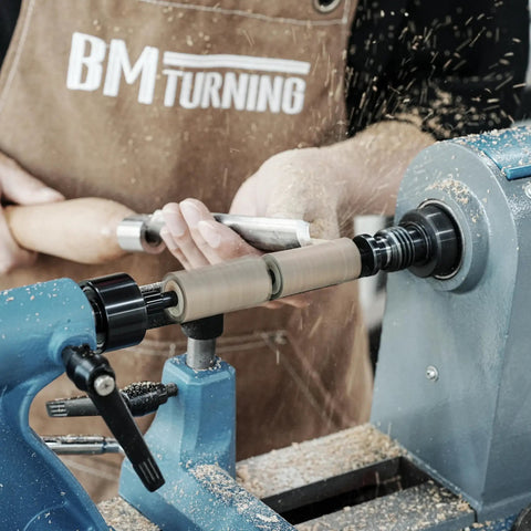 Woodworker using Pen Mandrel Bundle For Woodturning Lathe With Mandrel Saver, 2MT Taper, crafting a pen at a lathe machine.