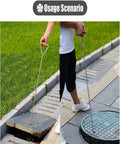 Person using Built Tough Stainless Steel Manhole Cover Hook With Triangular Handle Portable Heavy Duty Sewer Lid Lifter at drain.