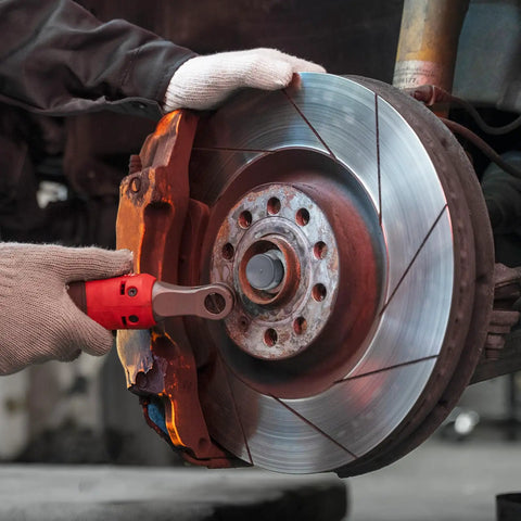 Mechanic installing Heavy Duty 4 Pack 1.98 Inch Grey Rubber Bearing Dust Caps on trailer wheel hub, close-up view.