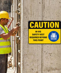 Caution Hi Vis Safety Vest Required Beyond This Point Sign Durable Rust Free Aluminum With UV Protected Print Waterproof Outdoor Warning Sign For Industrial Areas Highly Reflective For Day And Night Visibility, mounted on concrete wall