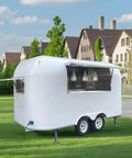 Custom Stainless Steel Food Truck Trailer With Turnkey Kitchen Setup For Mobile Coffee Or Hot Dog Business Built Heavy Duty To Level Up Your Street Vendor Hustle Today, shown from the rear on grass.