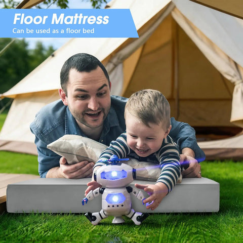 Father and child on 3 Inch Memory Foam Camping Pad For Car Camping And Tents, playing with a toy robot in front of a tent.