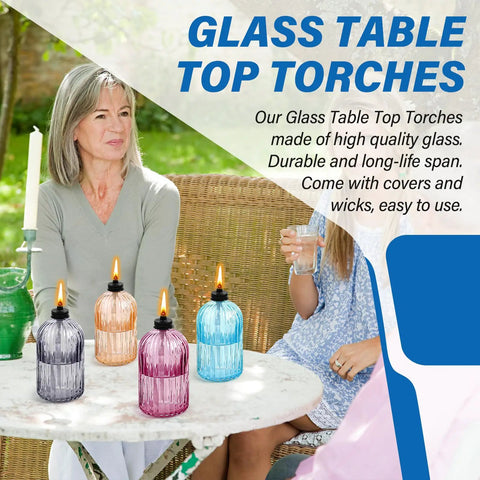 Glass Tabletop Torch Set Four Pack For Outdoor Use With 13.5 Oz Citronella Fuel displayed on a patio table during daytime