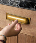 Person using Antique Brass Cup Pulls Zinc Alloy Cabinet Hardware for kitchen cabinet, 5 inch center, model 9632GT 128.