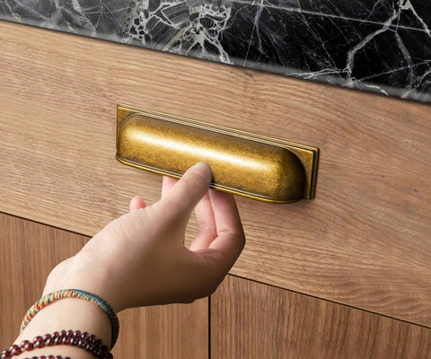 Person using Antique Brass Cup Pulls Zinc Alloy Cabinet Hardware for kitchen cabinet, 5 inch center, model 9632GT 128.
