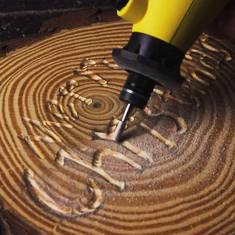Close-up of tool carving wood using 619 Piece Rotary Tool Accessories Kit With One Eighth Inch Shanks For Easy Drilling Cutting Grinding