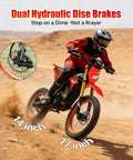 Rider on HAPPYRUN F18 Electric Dirt Bike Mid-Drive Motor 6000W Peak, showcased on desert terrain, dual hydraulic brakes visible