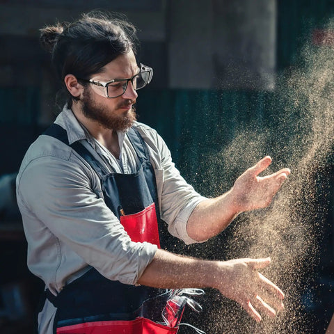 Man wearing slip on clear side shields for prescription glasses, soft TPU eyewear protectors against dust and debris, working indoors