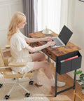 Person using laptop on 32 Inch Home Office Desk With Drawers And Storage For Gaming, Study Or Writing, Includes Fabric Drawers in Rustic Brown