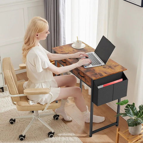 Person using laptop on 32 Inch Home Office Desk With Drawers And Storage For Gaming, Study Or Writing, Includes Fabric Drawers in Rustic Brown