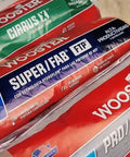 Various brands of paint roller covers including Wooster, shown in packaging, for painting walls and ceilings with smooth finishes.