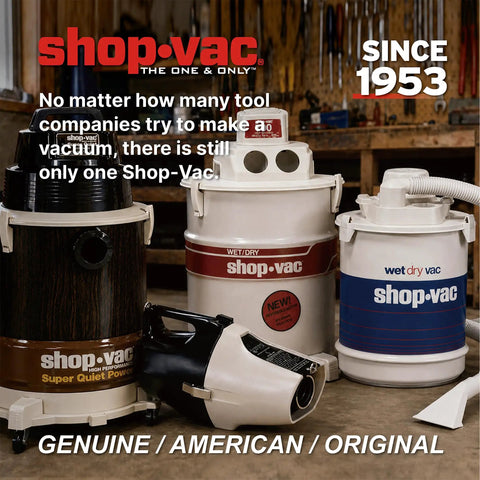 Four vintage Shop-Vac models from since 1953 displayed on a wooden workshop table.
