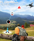 Grab And Go Foldable 2K HD Camera Drone With GPS Auto Return flying over scenic landscape with two people sitting on log.