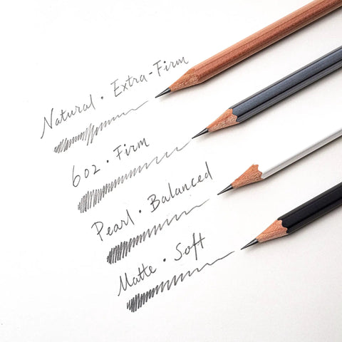 Four pencils with varying firmness writing lines, showcasing different graphite grades. Pearlescent White Pencils, 12 Pack For Journaling And Writing, Incense Cedar, Premium Japanese Graphite, Balanced Lead, Smooth, Easy Erasable, Perfect For Note Taking And Creative Sketching feature visible.