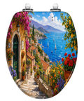 Elongated Mediterranean Coastal Village Colorful Flowers Toilet Seat showing scenic coastal view with vibrant flowers.