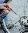 Applying Heavy Duty Chain Lube For Gears And Chains With Beefy Pro Grade Formula to a bike gear with Smart Lock Sprayer