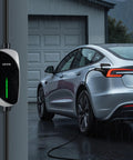Tesla Level 1 2 Portable EV Charger 16 Amp With 25 Ft Cable plugged into a grey Tesla in light rain, charging at garage.