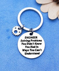 Stainless steel keychain with "Engineer Solving Problems You Didn't Know You Had" engraving on a blue background.