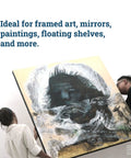 Two people mounting large art with Built To Last Heavy Duty French Cleat Hanger Kit For Mirrors And Pictures, 30 Inch Aluminum Z Bar