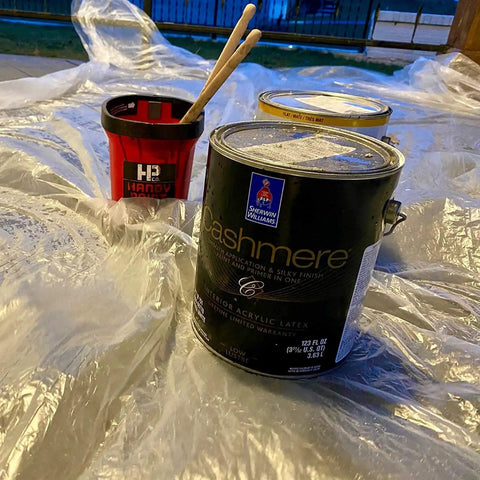 20 Pack 9x12 Ft Plastic Drop Cloths For Painting And Home Projects Waterproof Dustproof Tarp Shield with paint cans on top