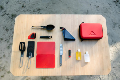 Alpine Deluxe Outdoor Kitchen Set With Zippered Carry Case BPA Free Tools displayed on a wooden surface, red and black accents.