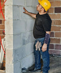 Lightweight Cut Resistant Wrist Guards With Breathable Mesh Sleeves For Mechanics And Yard Work on a worker inspecting a wall.
