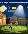 2 Pack Solar Street Light 180000 Lumens Outdoor LED Flood Light illuminating a yard with children playing, dusk setting, security lighting.