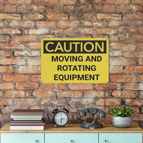 Watch Out Caution Moving And Rotating Equipment Sign Made From Rust Free Aluminum on a brick wall above a shelf.