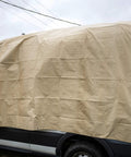 Heavy Duty Waterproof Tarp 20 Ft By 30 Ft 12 Mil Thick Tan Tarp With Reinforced Corners covering a vehicle for protection