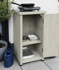 Backyard Ready Weatherproof Outdoor Storage Cabinet With Potting Bench Table Shelves And Rust Proof Metal Top For Patio And Garden Easy Assembly With Numbered Parts Water Seal Coating Wooden Planting Work Station with open door showing shelves on patio.