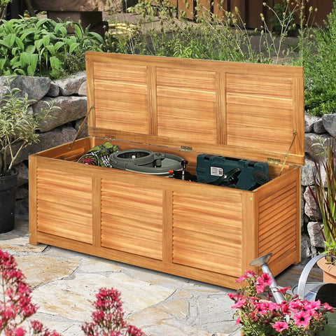 46 Gallon Acacia Wood Deck Box With Outdoor Storage Bench For Patio Cushions And Tools Built Like A Tank Sturdy Solid Wood Frame With Teak Oil Finish Weather Resistant Garden Storage Chest For Backyard Gear showing open lid with tools inside.