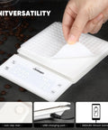 White Spot On Accuracy Digital Kitchen Scale with textured mat lifted, USB charging port, and coffee beans.