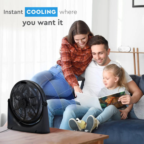 Family sitting on sofa near 20 Inch High Velocity Floor Fan With Wall Mount And 180 Degree Tilt, enjoying air circulation.