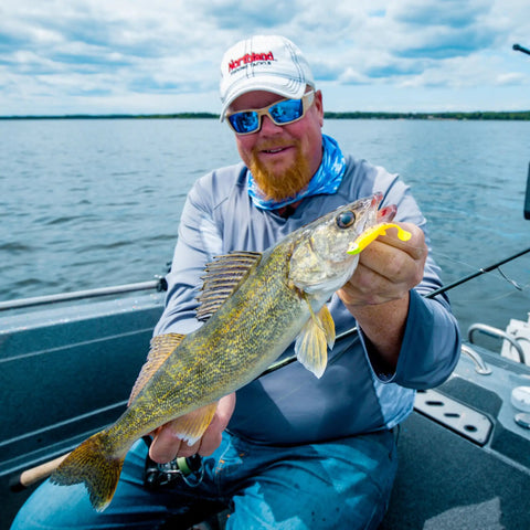 Angler holding a walleye caught with Mimic Minnow Swimbait Lure Kit With Jig Head Design Assorted Sizes And Colors For Walleye Bass