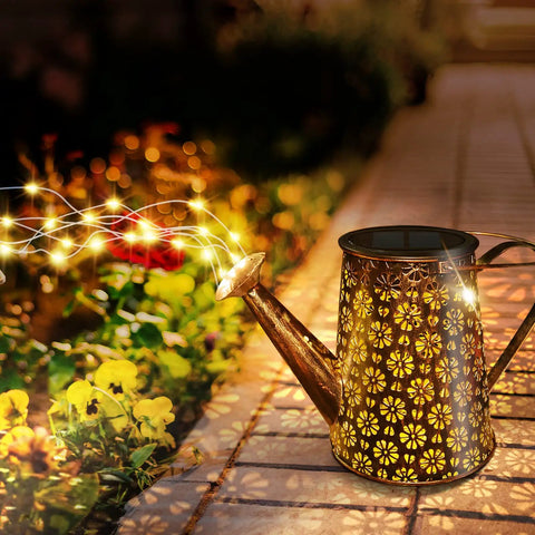 Solar Powered Watering Can Lantern Lights For Garden Decor illuminating flowers with LED string lights at night