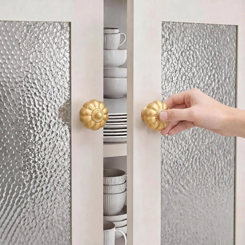 Solid Brass Cabinet Knobs And Gold Pumpkin Drawer Pulls Featuring Vintage Floral Accents For Kitchen Cupboards And Dressers Heavy Duty 6 Pack 1 1 8 Inch- A hand reaching for gold pumpkin cabinet knobs on modern glass cabinet doors.