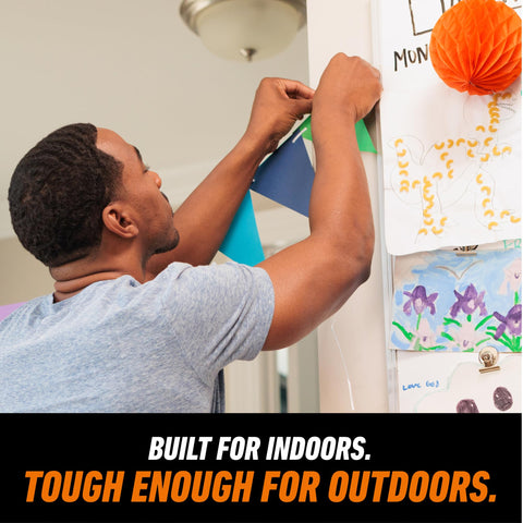 Person using Mounting Putty For Walls Natural Tan Color 168 Pre Cut Squares Removable And Repositionable Non Toxic on decor