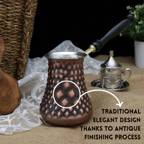 Handmade Copper Turkish Cezve Set Of 3 Extra Large And Medium Pots For Rich Turkish Coffee Dope Copper Pot With Pyramid Pattern And Antique Finish For Home Barista Use with wooden handle shown from the side with a focus on design.