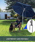 Person sitting under umbrella with Adjustable Portable Umbrella Base With Heavy Duty Metal Holder Stand Auger for Sand Grass Flag
