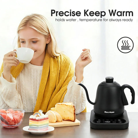 Woman enjoying coffee beside Precision Temperature Control Electric Kettle With 316L Stainless Steel, 1F Precision, Rapid 1000W Heating, Keep Warm Mode, 0.8L Capacity For Pour Over Coffee, Tea, And Milk, No-Nonsense Rust-Resistant, Scale-Resistant on table with desserts