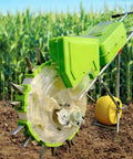 All In One Garden Push Seeder With Wheel Dual Hopper Seed Sower And Fertilizer Applicator in front of cornfield