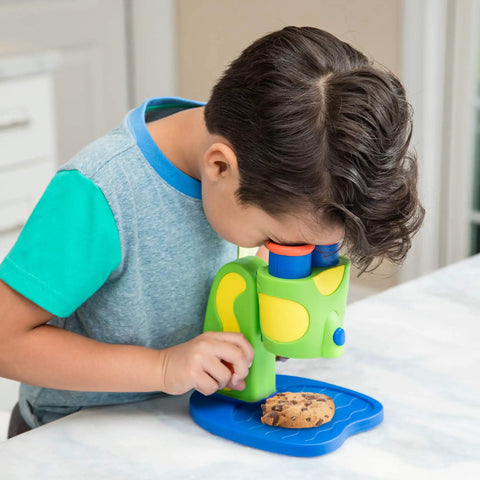 Rad Microscope For Curious Kids Ages 3 And Up A Hands On Science Toy That Sparks Discovery Of The Tiny World With Easy Focus Lenses And Colorful Slides For Fun Safe Kid Friendly Learning. Child using green plastic microscope with cookie slide
