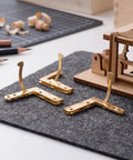 Set Of 20 Gold Lid Support Hinges For Wooden Jewelry Boxes, 92 Degree Quadrant Folding Hardware on grey felt mat