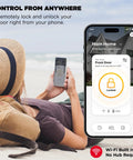 Person relaxing on beach using smartphone app to control Lock Down Your Home Base With This Fly WiFi Smart Lock That Skips The Hub Hassle Entirely For Pure Keyless Entry Perfection Via Touchscreen Deadbolt In Matte Black.