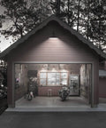 Outdoor Gooseneck Barn Light Fixture 14 Inch With Dusk To Dawn Sensor illuminates a garage exterior at night.