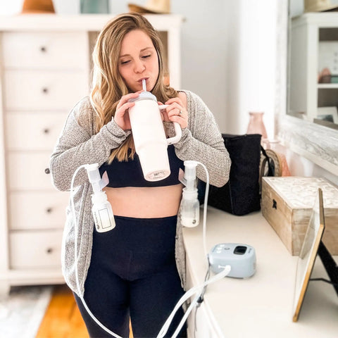Woman using Powerhouse Rechargeable Cordless Breast Pump With Hospital Strength Suction and Dual Adjustable Settings while drinking.